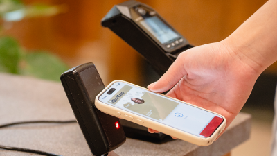 student uses mobile wallet to access dining hall