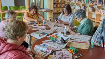 Stock photo of older women crafting together around a table
