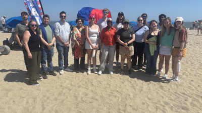 A group of people standing on a beach.