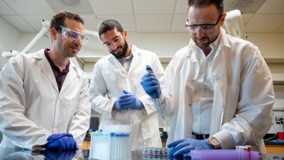 Alex Abramson, Ramy Ghanim, and Abdulraouf Abbas working in the lab.