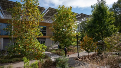 Image of micromobility user in the EcoCommons performance landscape adjacent to The Kendeda Building for Innovative Sustainable Design