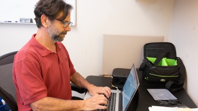 Grillo welcomes the challenge of "going to school" for almost every research story he writes. (Photo by Allison Carter)