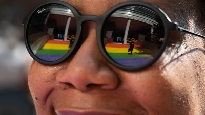 Buzz is reflected in Christen Steele’s glasses as she admires the Progress Pride Staircase at its grand opening in 2021. Photo by Allison Carter