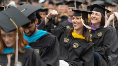 A celebratory fist pump during the master's ceremony last Spring. (Photo by Allison Carter)

