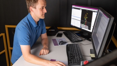 Pawel Golyski uses a computer to operate the CAREN during experiments.