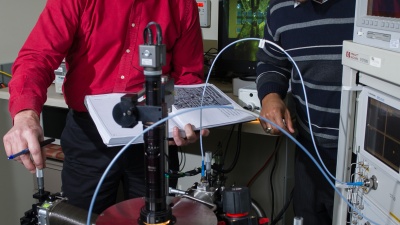 Professor John Cressler (left) and graduate student Adilson S. Cardoso work at a cryogenic probe station at Georgia Tech. (Georgia Tech Photo: Rob Felt)