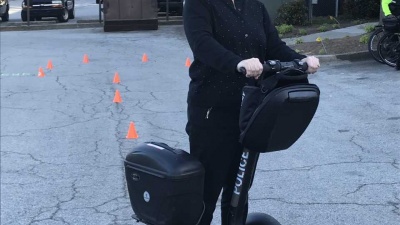 Brenda Morris, a graduate of the Citizen's Police Academy, learns to ride a Segway as part of the training.