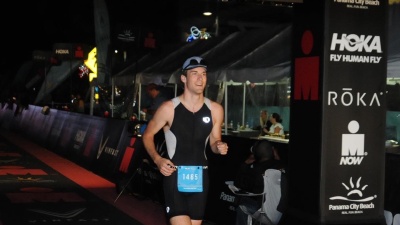 Colin Wegner crosses the finish line at the Panama City Beach Ironman Triathlon in November 2022. Submitted photo.&nbsp;
