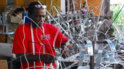An artisan from Trinidad and Tobago uses traditional skills to build an intricate wire frame that will support a large, elaborate Carnival costume. 