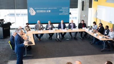 Georgia Tech Executive Vice President for Research Chaouki T. Abdallah (standing) addresses representatives of the Economic Development Administration and members of the Georgia Artificial Intelligence in Manufacturing (Georgia AIM) coalition Nov. 14, 2022. (PHOTO: Joya Chapman)