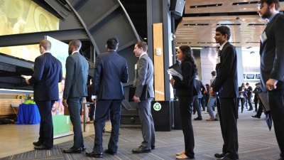 Students wait in line to talk to a recruiter at the spring all-majors career fair.