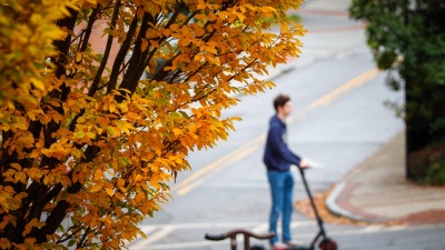 Student Rides a Scooter on Campus