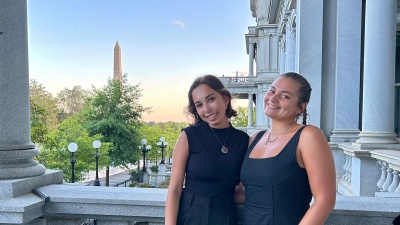 Students in the GTDC: Pathways to Policy program pose for a photo with the Washington Monument in the backgroumd.
