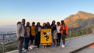 Students and staff with OMED’s Study Abroad and Global Innovation Project after going to the top of Table Mountain, overlooking the city of Cape Town in South Africa.