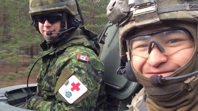 Corey Crisostomo (right) poses for a photo with a friend (left) during his service in the United States Army.
