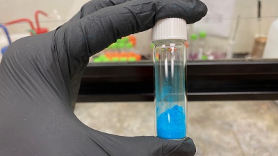 The vial shown contains a blue powder, HKUST-1, a metal-organic framework (MOF) material. (Credit, Tania Evans, Georgia Tech)