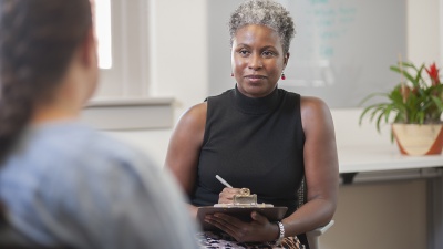 Janice Harewood, licensed psychologist and assistant director for Outreach and Wellness, talks with a student in the Counseling Center.