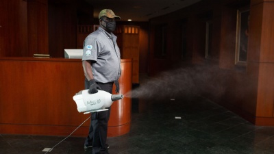 Seth Osekre uses a disinfecting fogger. The disinfectant has a fast evaporation rate, leaving no residue or odor behind. (Photo by Allison Carter)