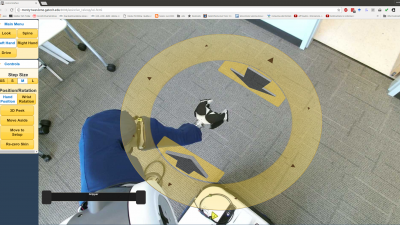 Image shows the view through the PR2’s cameras showing the environment around the robot. Clicking the yellow disc allows users the control the arm. (Credit: Phillip Grice, Georgia Tech)