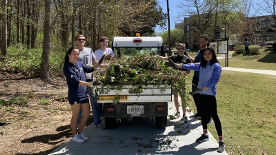 Volunteers from Students Organizing for Sustainability remove ivy from an area near The Kendeda Building for Innovative Sustainable Design in April 2022.
