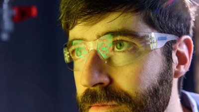 Physicist Peter Yunker applies mathematical equations to enemy colonies of dueling cholera bacteria to accurately predict the speed dynamics of their phase separation into divided territories, a process similar to the separation of oil and water. The equations were originally used to describe phase separate in materials, namely mixed metals (Model A equations). Credit: Georgia Tech / Rob Felt