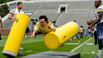 Students ran through eight different drills, including tackling dummies, during the International Football Clinic.