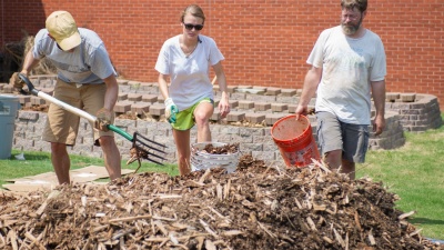 Students and faculty working on the campus garden