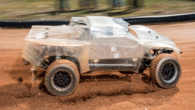At the Georgia Tech Autonomous Racing Facility, researchers are studying a one-fifth-scale autonomous vehicle as it traverses a dirt track. The work will help the engineers understand how to help driverless vehicles face the risky and unusual road conditions of the real world. (Credit: Rob Felt, Georgia Tech)