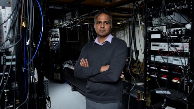 Chandra Raman, an associate professor in the Georgia Tech School of Physics, is shown in his laboratory with equipment used to study Bose-Einstein condensates. (Credit: Rob Felt, Georgia Tech).