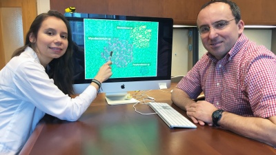 Georgia Tech Doctoral Student Maria Juliana Soto-Girón and School of Civil and Environmental Engineering Professor Kostas Konstantinidis are shown with images of bacteria. Research done with scientists from the U.S. Environmental Protection Agency documented bacteria in shower hoses taken from hospital patient rooms. (Credit: John Toon, Georgia Tech).