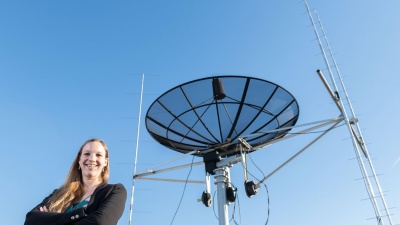 Georgia Tech assistant professor Mariel Borowitz is shown with satellite communications equipment. Dramatic growth in the generation and collection of data will change the way federal agencies make data available. (Photo: Allison Carter, Georgia Tech)