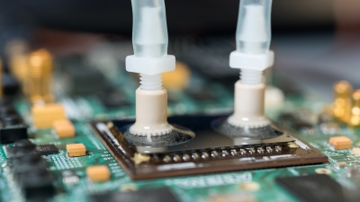 Liquid ports carry cooling water to specially designed passages etched into the backs of FPGA devices to provide more effective cooling. The liquid cooling provides a significant advantage in computing throughput. (Credit: Rob Felt, Georgia Tech)