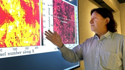 Georgia Tech professor David Citrin is shown with images produced by a terahertz imaging technique. Researchers studied a 17th century painting using a terahertz reflectometry technique to analyze individual paint layers.(Credit: John Toon, Georgia Tech)