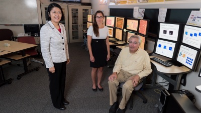 With support from the Centers for Disease Control and Prevention (CDC), Georgia Tech is examining death certificate data to determine what can be learned from these records. Shown are May Dongmei Wang, a professor in the Department of Biomedical Engineering at Georgia Tech and Emory University, and the School of Electrical and Computer Engineering; Paula Braun, entrepreneur-in-residence at the CDC; and Mark Braunstein, M.D., a professor of the practice in Georgia Tech’s College of Computing. (Credit: Rob 