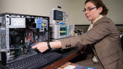 Georgia Tech researcher Alenka Zajic measures electromagnetic emissions from various components of a desktop computer. The researchers have studied emissions from desktop and laptop computers, as well as cellphones. (Credit: Rob Felt)