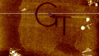Image shows patterned etching of graphene oxide flakes to create a logo. The etching achieved a depth of 0.9 nanometers.
