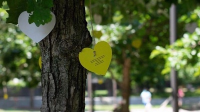 Paper hearts hangs from a campus tree displaying messages from a member of the campus community. Photo courtesy of SMILE