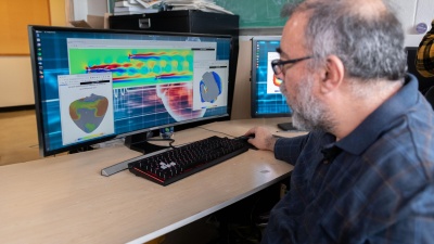 Flavio Fenton, a professor in the School of Physics at the Georgia Institute of Technology, examines cardiac and fluid flow simulations created on a system that uses graphics processing chips designed for gaming applications and software that runs on ordinary web browsers. (Photo: Allison Carter, Georgia Tech)