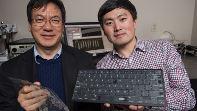 Georgia Tech Professor Zhong Lin Wang (left) and graduate research assistant Jun Chen display their new self-powered keyboard. The device could provide a stronger layer of security for computer users. (Credit: Rob Felt)