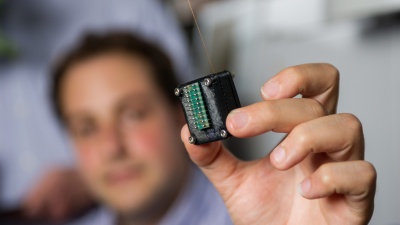 Milad Navaei, a graduate research assistant, holds the micro gas chromatograph, which is being developed by GTRI researchers for early detection of diseases in crops. The technology’s portability could allow farmers to quickly evaluate the health of their crops and address possible threats immediately, thus reducing crop losses. (Georgia Tech Photo: Rob Felt)