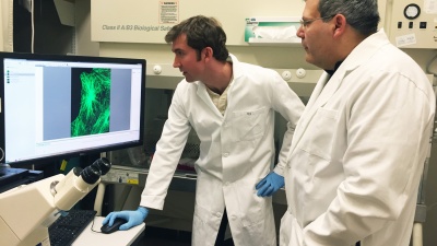Researchers Phil Santangelo and Eric Alonas with a spinning disk confocal microscope used to image cells. Santangelo is a professor in the Wallace H. Coulter Department of Biomedical Engineering at Georgia Tech and Emory University; Alonas is a Georgia Tech graduate student. (Credit: John Toon, Georgia Tech)