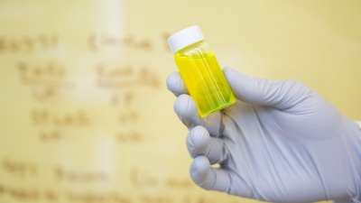 Looking like an innocuous vial of liquid, programmable drugs will be able to communicate directly with our biological systems. (Credit: Allison Carter, Georgia Tech)