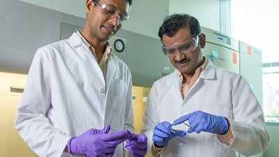 Dr. Krishnendu Roy (right) and Rachit Agarwal examine a silicon wafer. (Credit: Rob Felt)