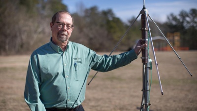 John Trostel, director of the Severe Storms Research Center (SSRC), poses with a sensor that is part of the North Georgia Lightning Mapping Array, a network of 12 such sensors located around the metropolitan Atlanta area to detect lightning that may indicate storm intensification. (Credit: Branden Camp, Georgia Tech Research Institute)