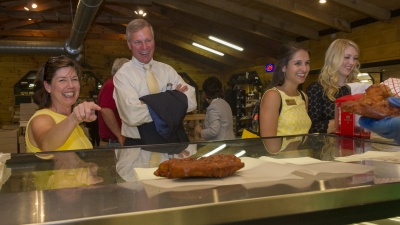 Chief of Staff Lynn Durham orders at Mercier Orchards in Blue Ridge, Georgia as President G.P. "Bud" Peterson watches following a tour of the facility on Thursday, June 18, 2015.