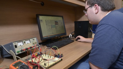 Austin Pettit of Lithia Springs High School works out the details of the control system of a hybrid-electric unmanned aerial vehicle. (Credit: Rick Robinson)
