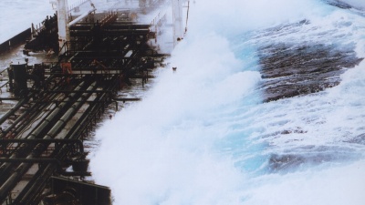 A 60-foot rogue wave hits the OVERSEAS CHICAGO tanker as it was headed south from Valdez, Alaska in 1993. The ship was running in 25-foot seas when the monster wave hit it on the starboard side. (Credit: Captain Roger Wilson courtesy of NOAA)