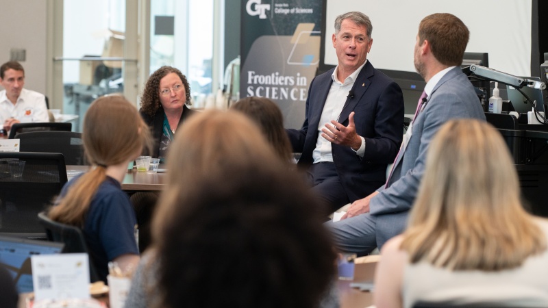 R. Shane Kimbrough speaks in front of room of people during a fireside chat