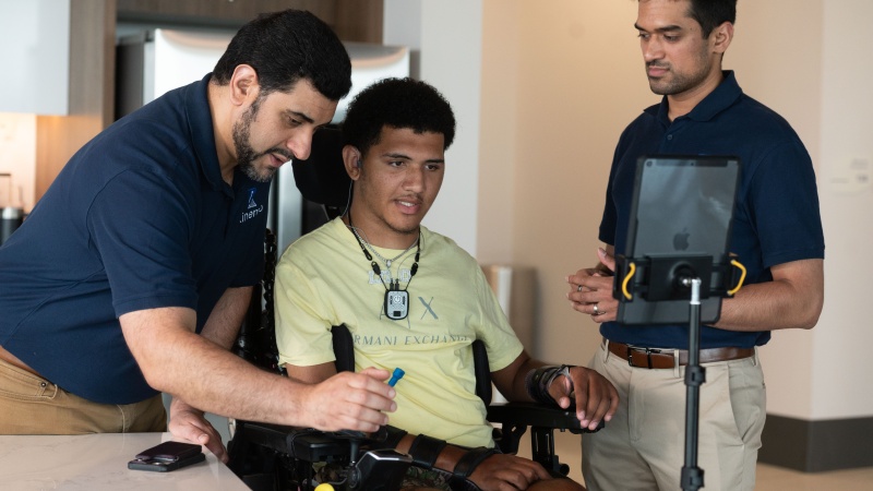 Two researchers and a patient using the Kinemo technology. 
