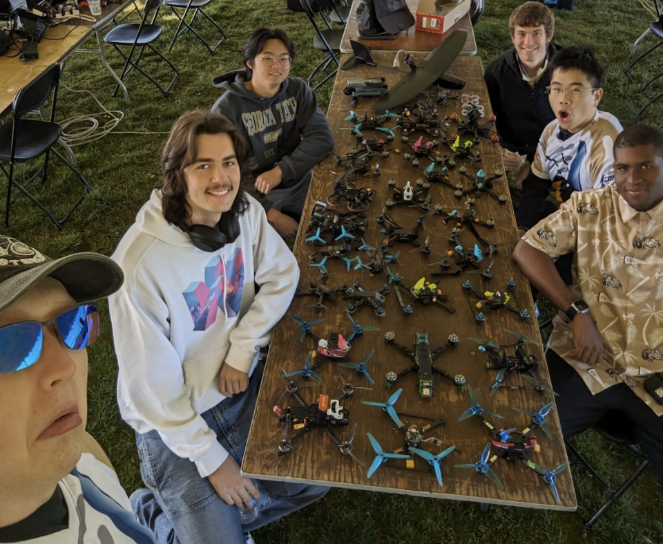 RotorJackets pose in front of their drones at the Collegiate Drone Racing Championship